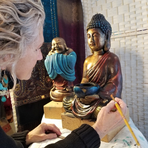 Shali Sanders painting her Buddah statues